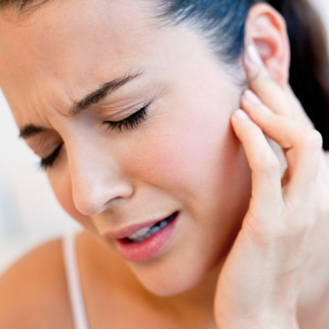 woman wincing in pain