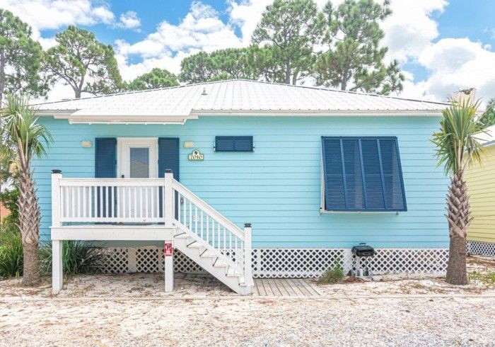 A blue house with a white porch and stairs.