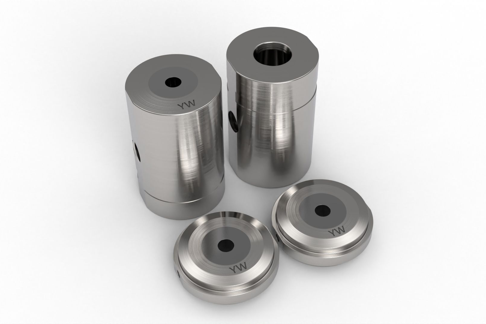 Four cylindrical metal parts with black central holes and small side screws, on a white surface.