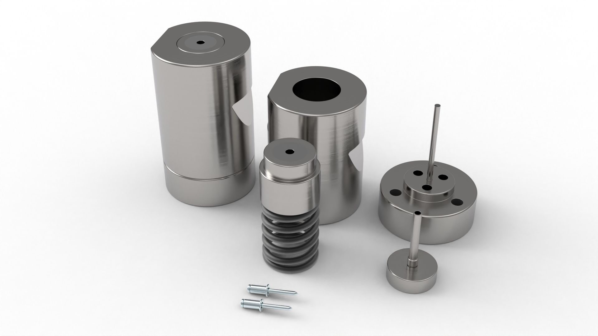 Metal cylindrical tools and components on a white surface; some with holes and stems.
