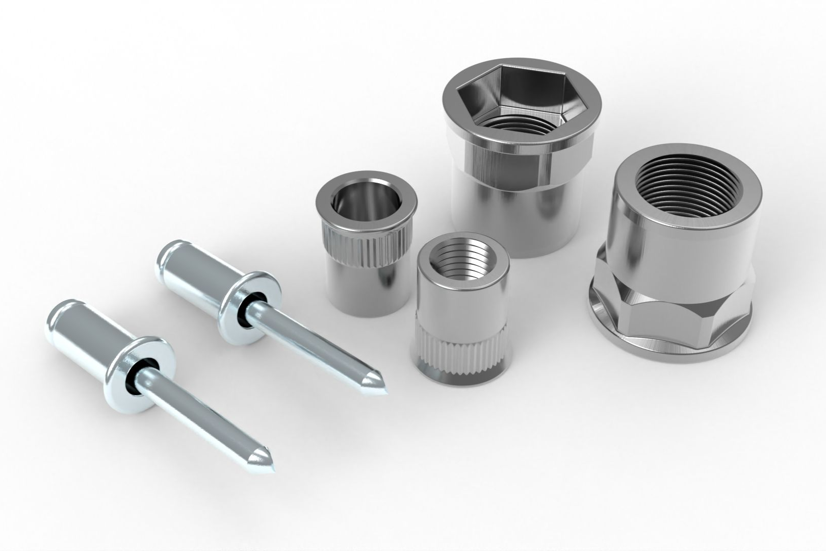 Silver rivets and threaded inserts on a white surface.