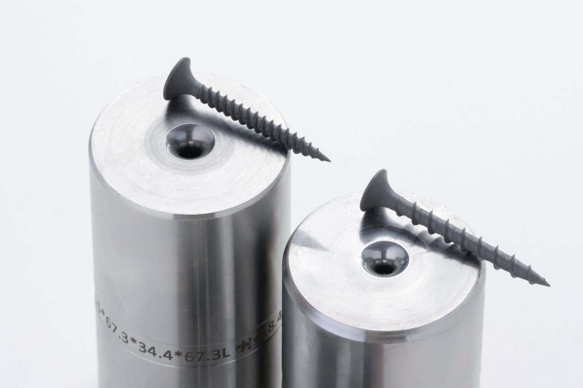 Two metal dies with screws, on a white background.