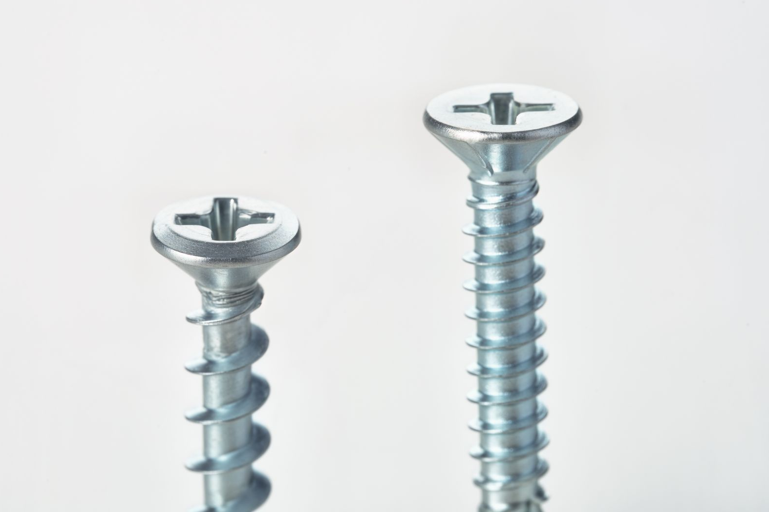 Two silver screws with Phillips head, one short, one long.