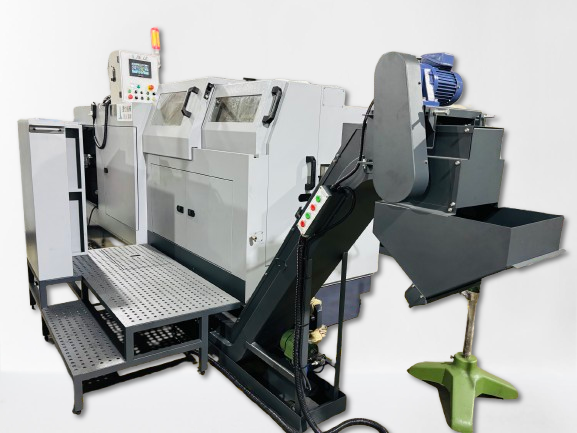 CNC machine with automated chip removal and control panel. Gray metal, in a workshop setting.