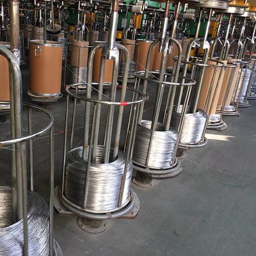 CNC machine with integrated chip conveyor and coolant system in a factory setting.