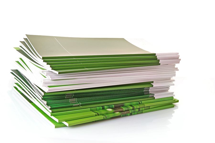 a stack of green and white books on a white background .