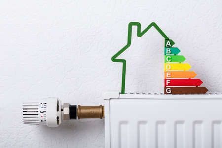 A radiator with a house shaped energy efficiency label on it.