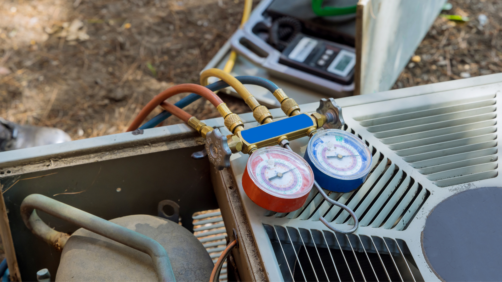 A close up of a refrigerator with two gauges attached to it.