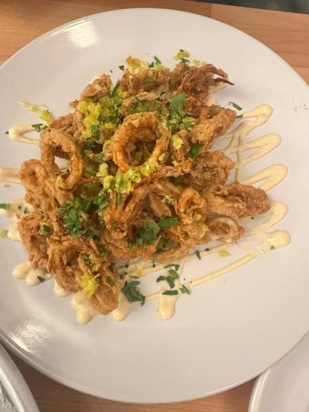A white plate topped with fried calamari