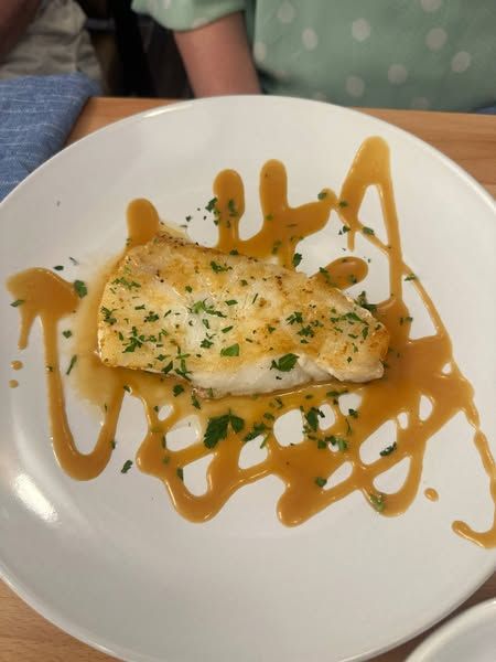 A white plate topped with a piece seabass in miso glaze