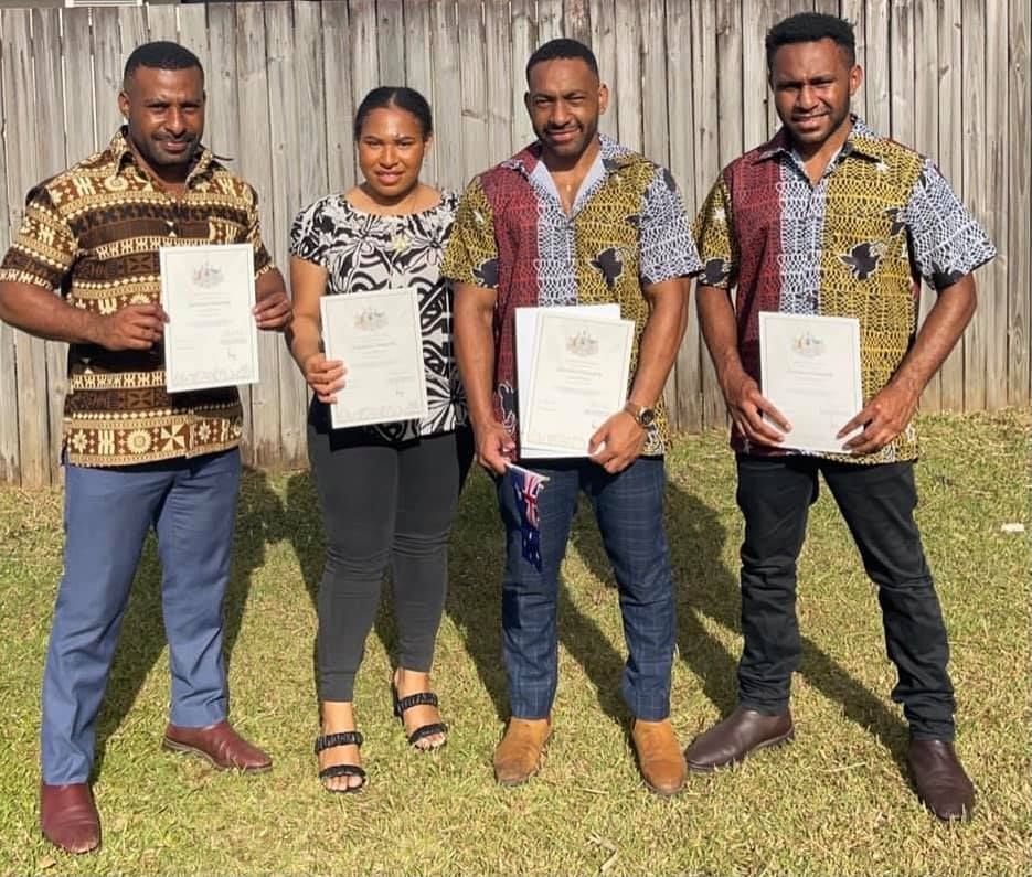 Four People Holding Documents — Immigration Agents in Cairns North, QLD
