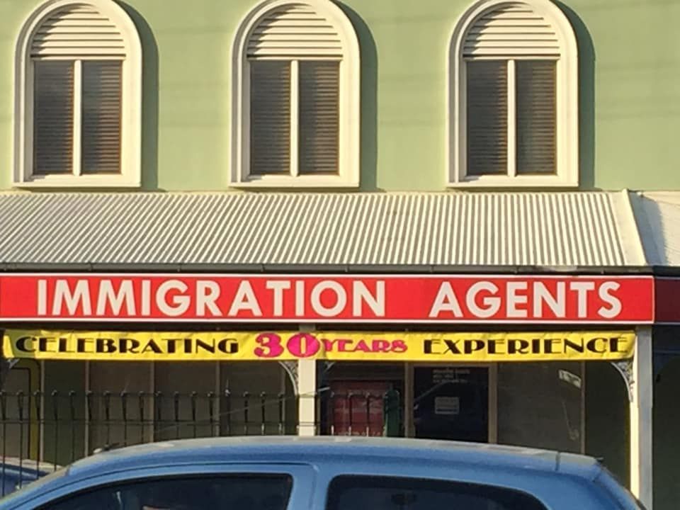 Sign for Immigration Agents With a Red Background — Immigration Agents in Cairns North, QLD