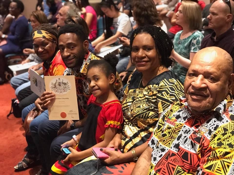 Family at a Naturalization Ceremony, Smiling — Immigration Agents in Cairns North, QLD