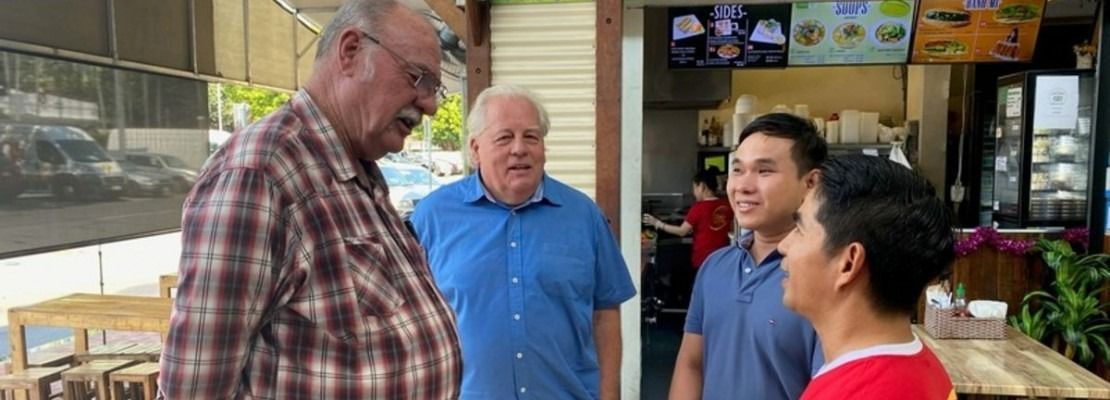 Four Men Standing Outside a Restaurant — Immigration Agents in Cairns North, QLD