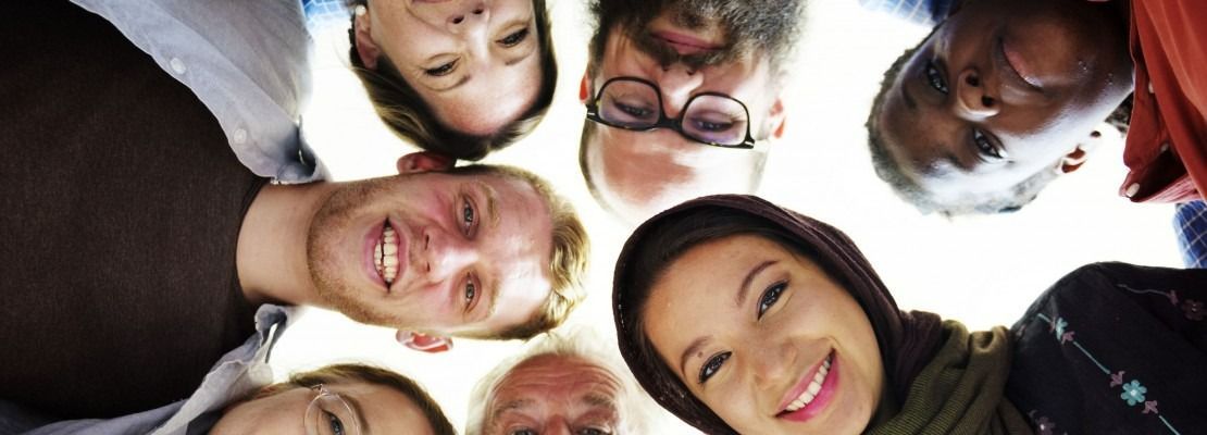A Diverse Group of People Looking Down and Smiling — Immigration Agents in Cairns North, QLD
