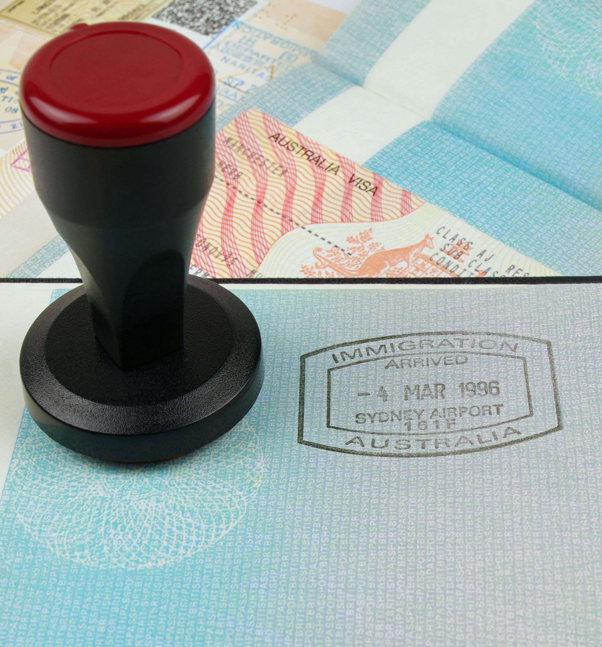 Black Stamp Pressing Into a Passport — Immigration Agents in Cairns North, QLD
