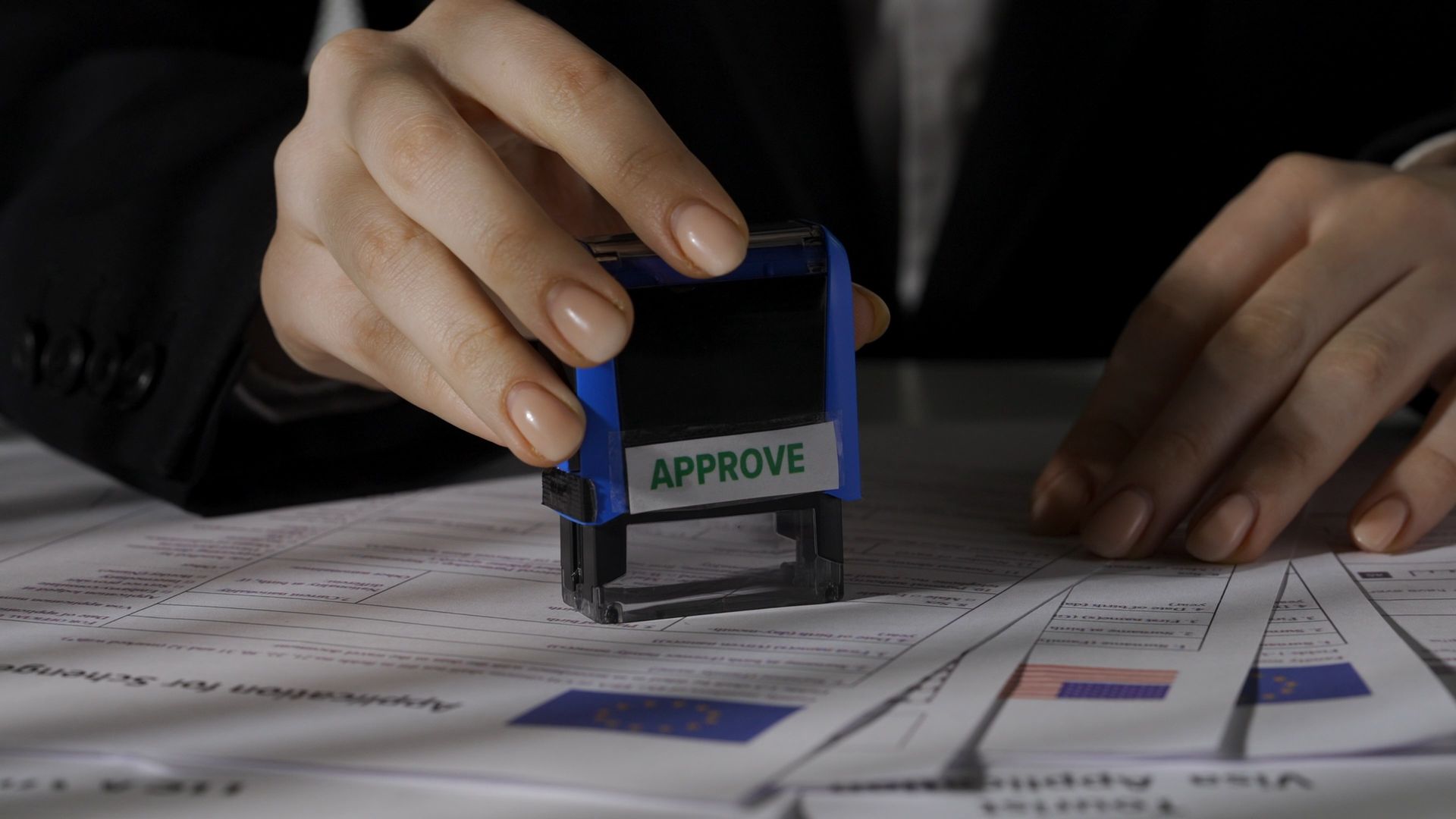 A Person's Hands Stamping a Document — Immigration Agents in Cairns North, QLD