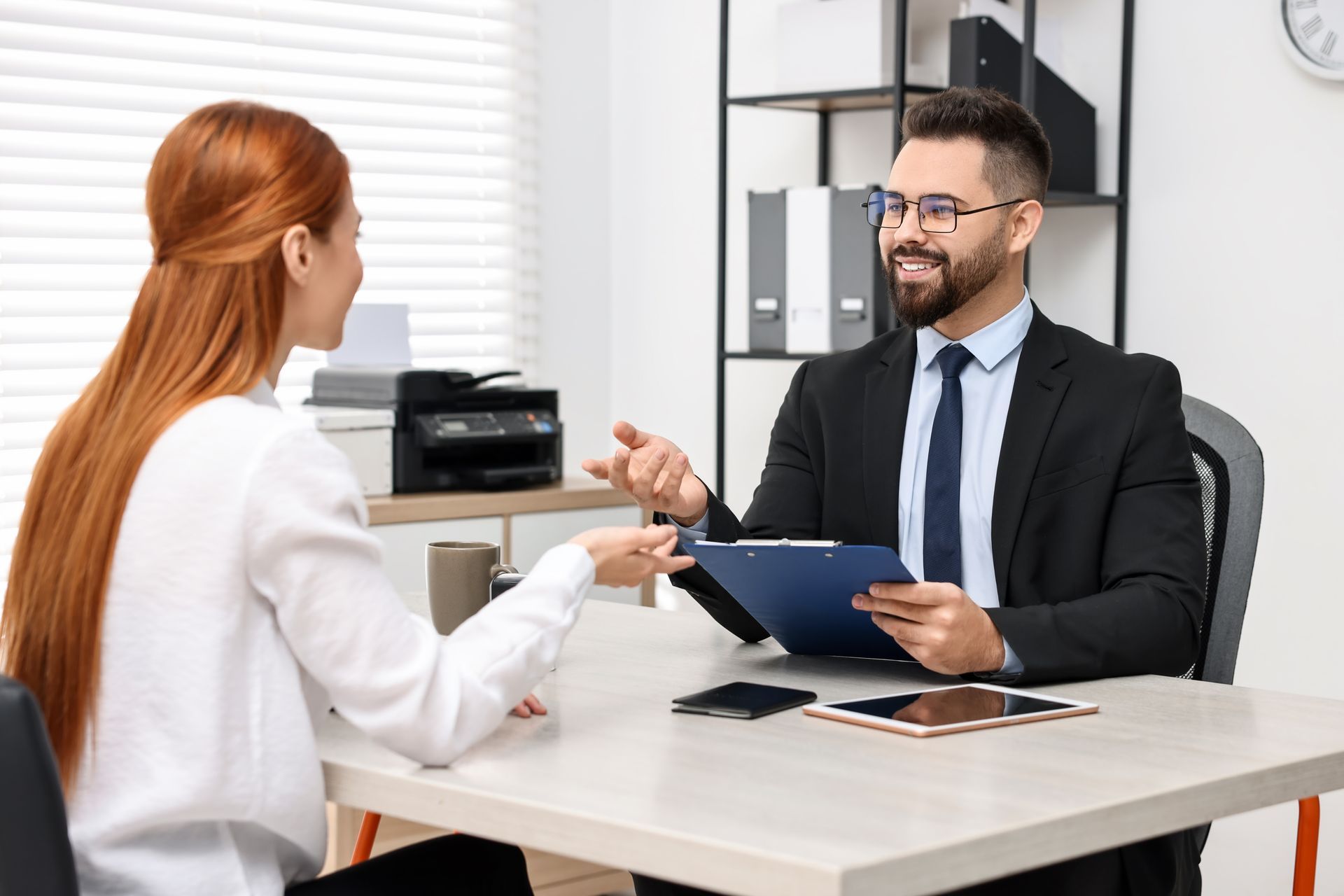 Woman and Man at a Desk in an Office, Having a Conversation — Immigration Agents in Cairns North, QLD