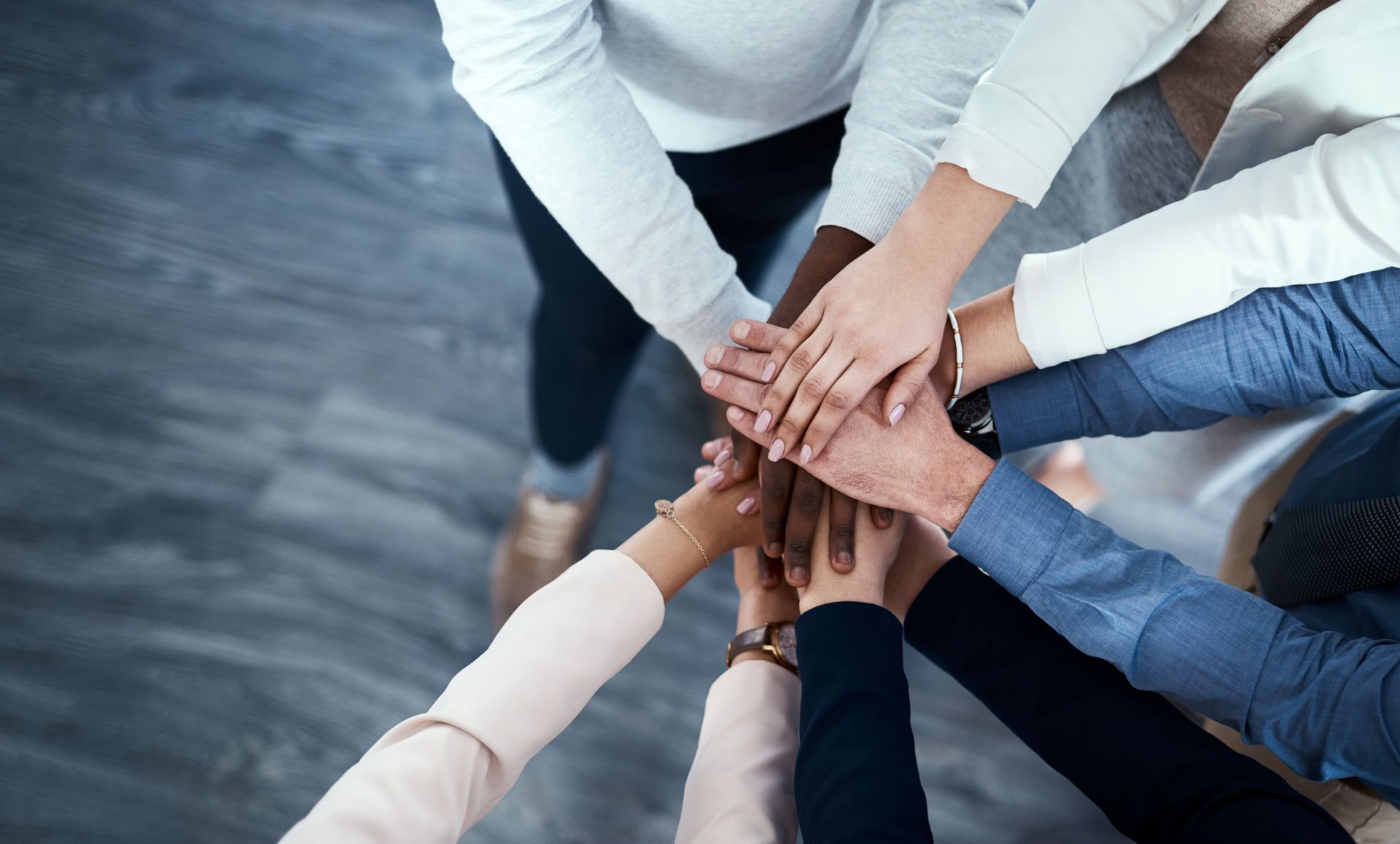 Hands of Diverse People Stacked Together in a Team Huddle — Immigration Agents in Cairns North, QLD