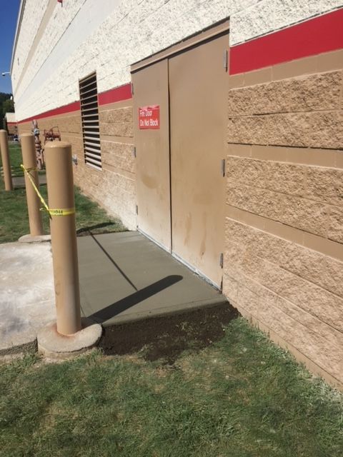 A Building With A No Parking Sign On The Side Of It — Rome, NY — EWS Sealcoating