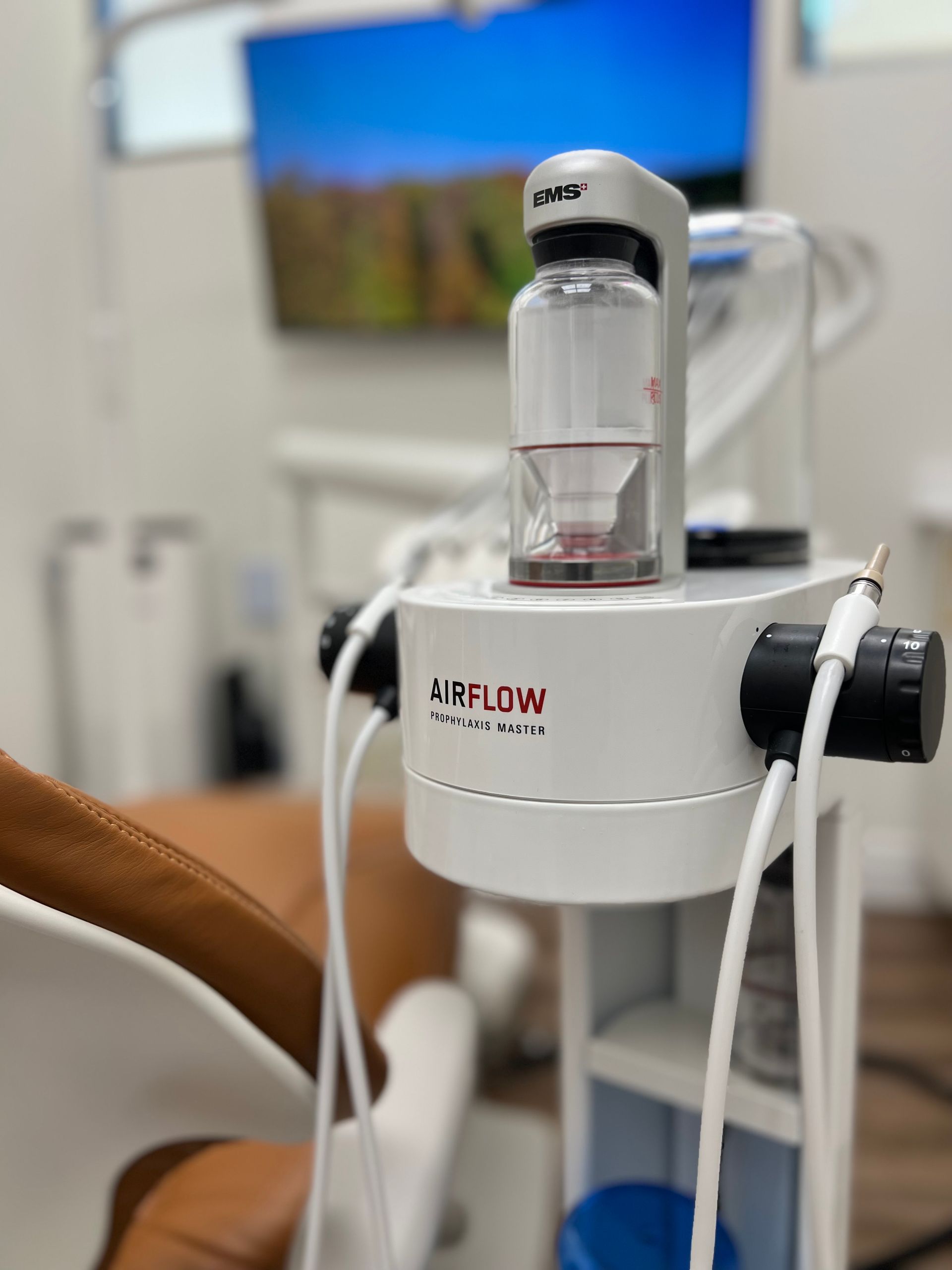 Medical device on a cart beside a patient’s arm, with tubing connected in a clinic room.