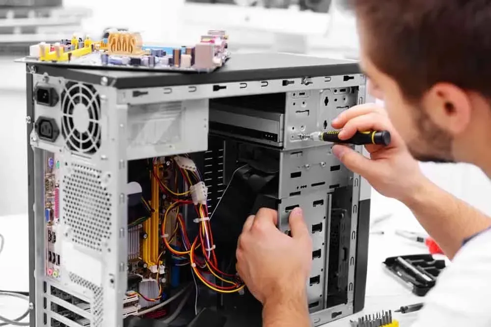 Man Repairing a Computer, Using a Screwdriver — Micromac Computers in Charmhaven, NSW
