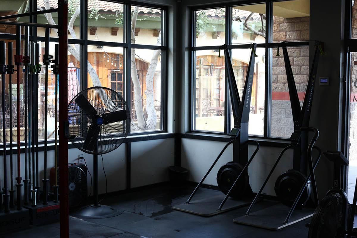 A room with a lot of windows and a fan