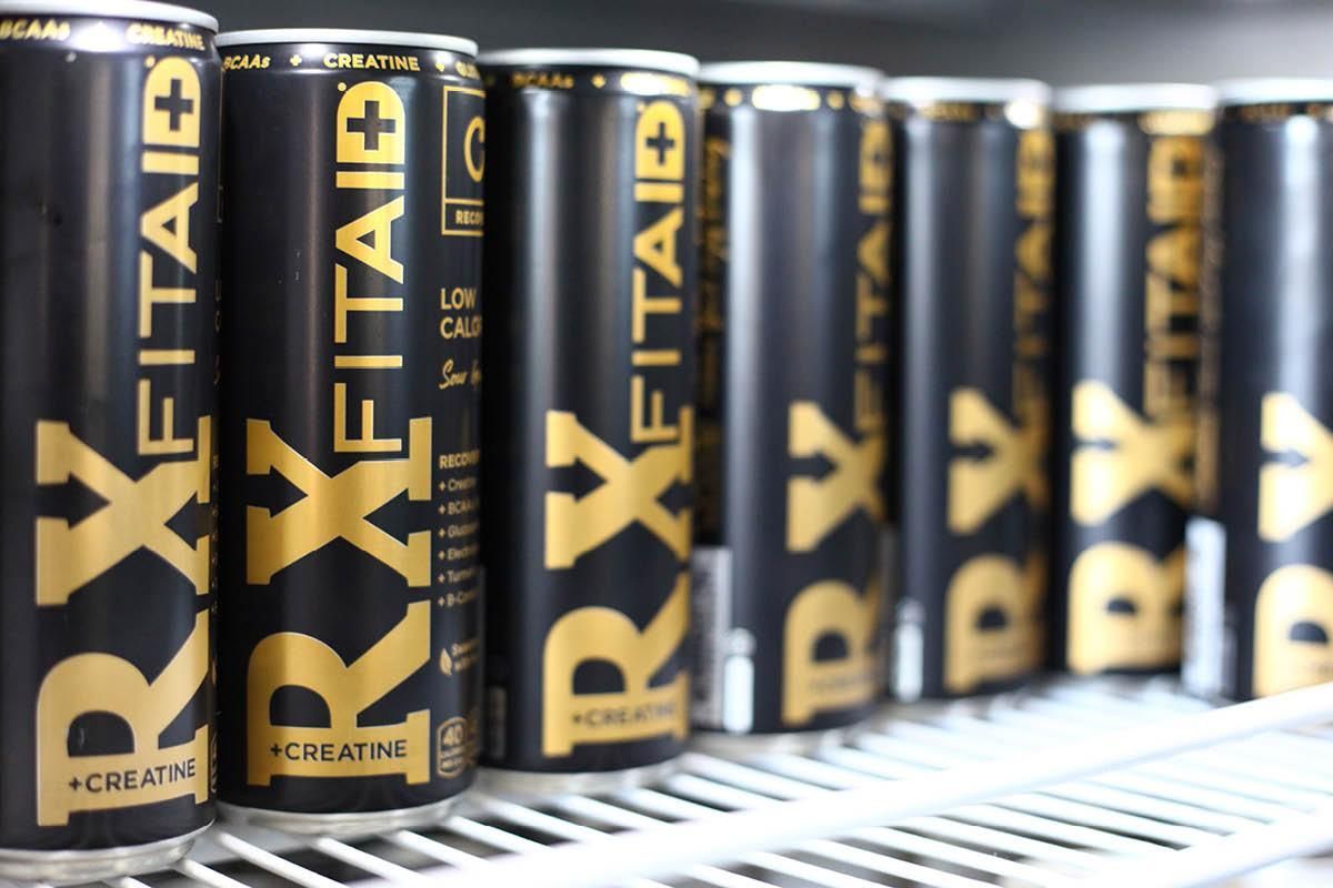 Several cans of rxfitaid are lined up on a shelf
