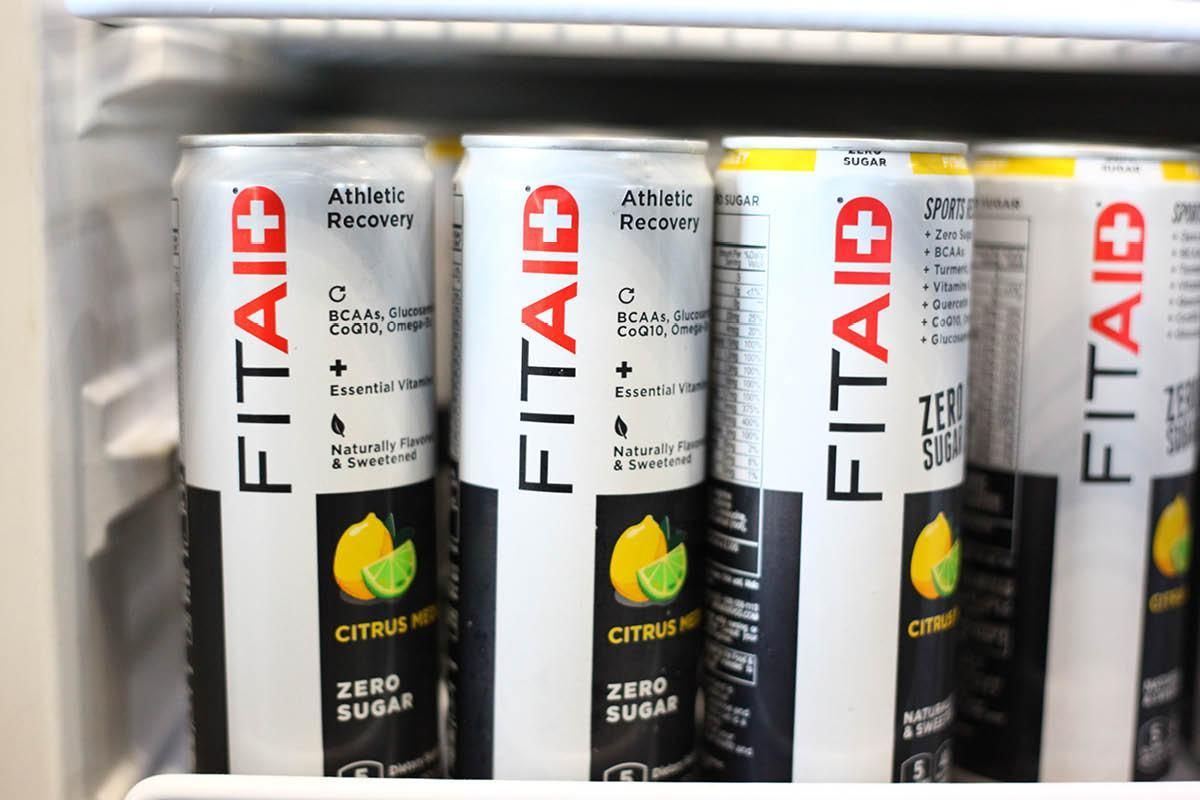 A row of cans of fit aid in a refrigerator