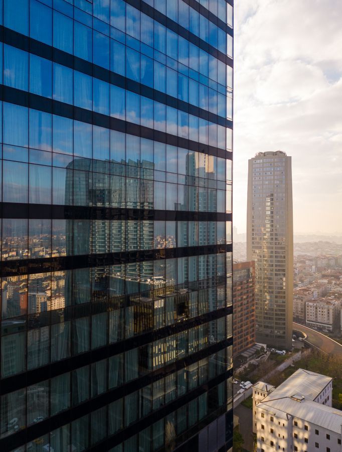 Modern skyscrapers with reflective glass exteriors. Cityscape view with sunny sky.