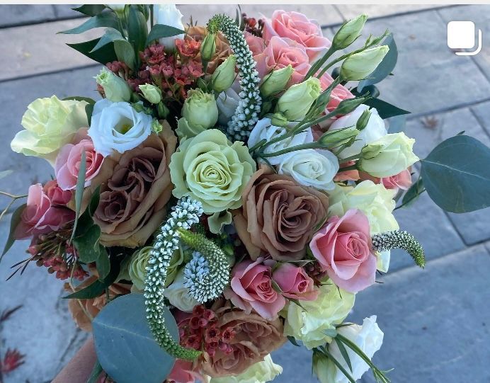 A person is holding a bouquet of flowers in their hand