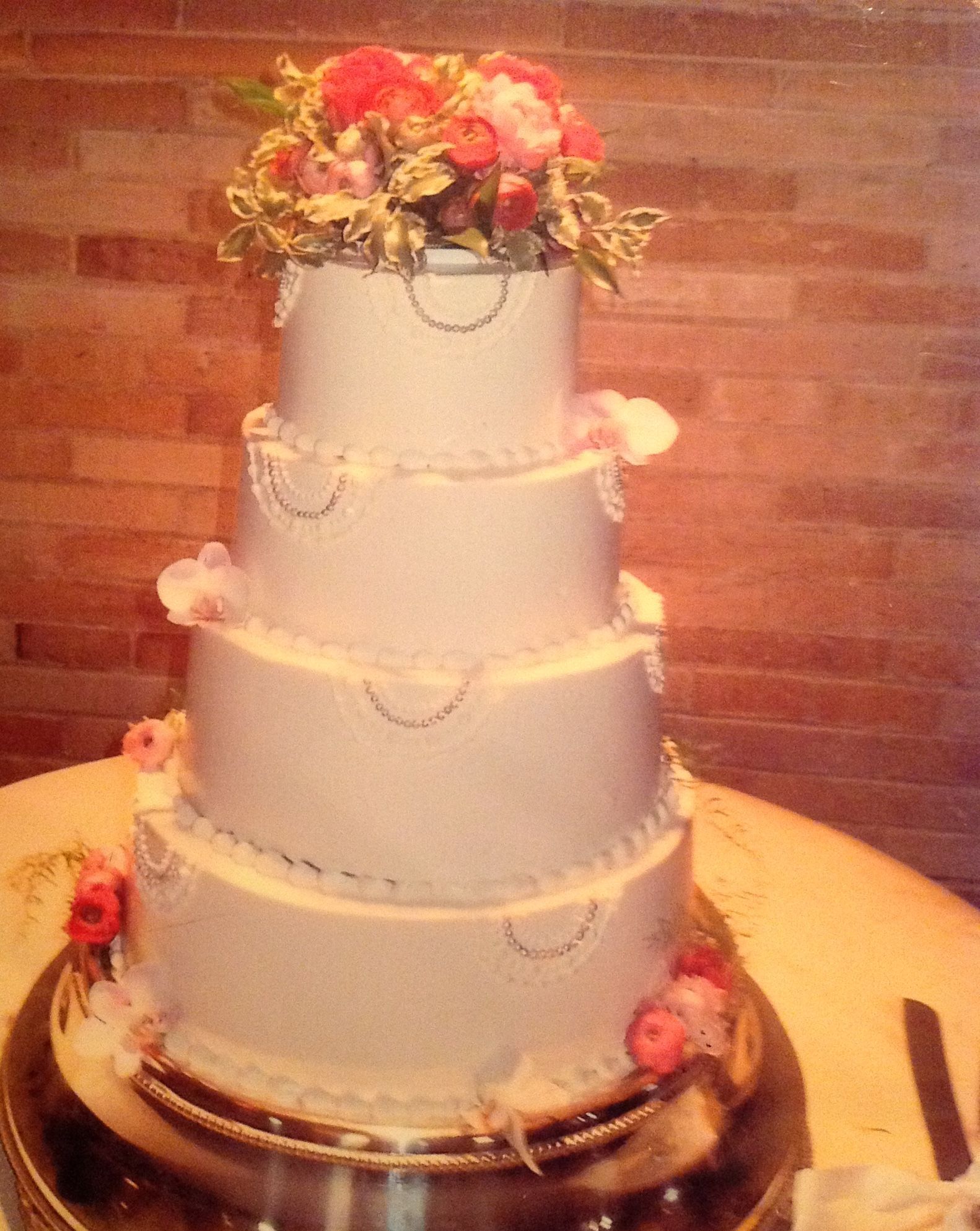 A wedding cake with flowers on top of it