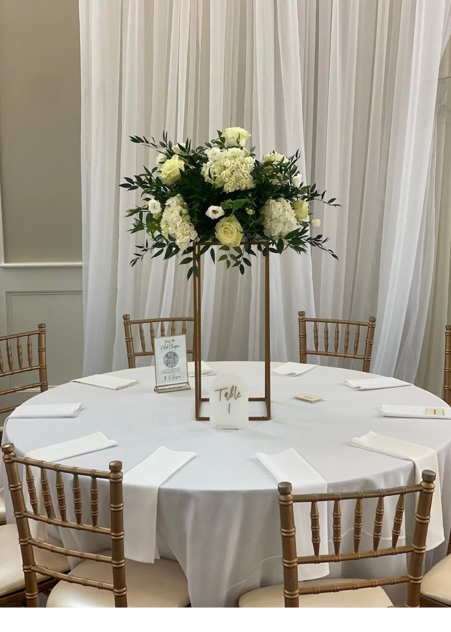 A table with a vase of flowers on it