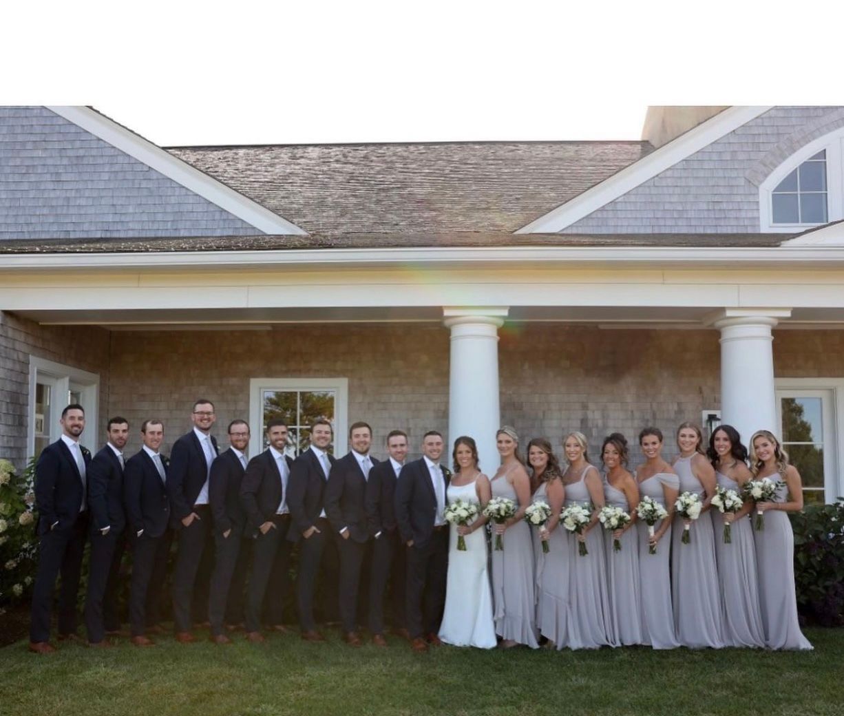 A group of people standing in front of a house