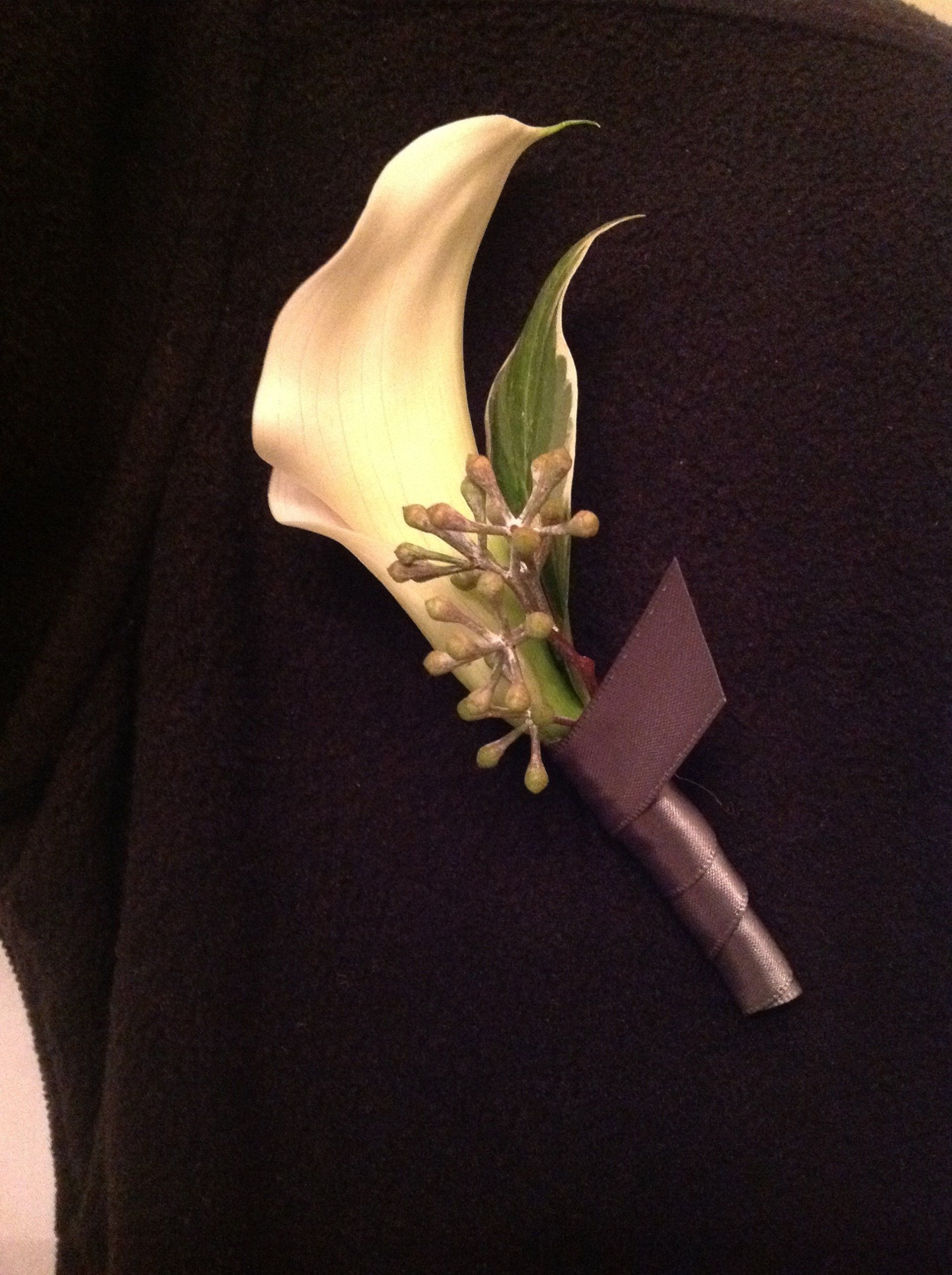 A close up of a flower on a person 's shoulder