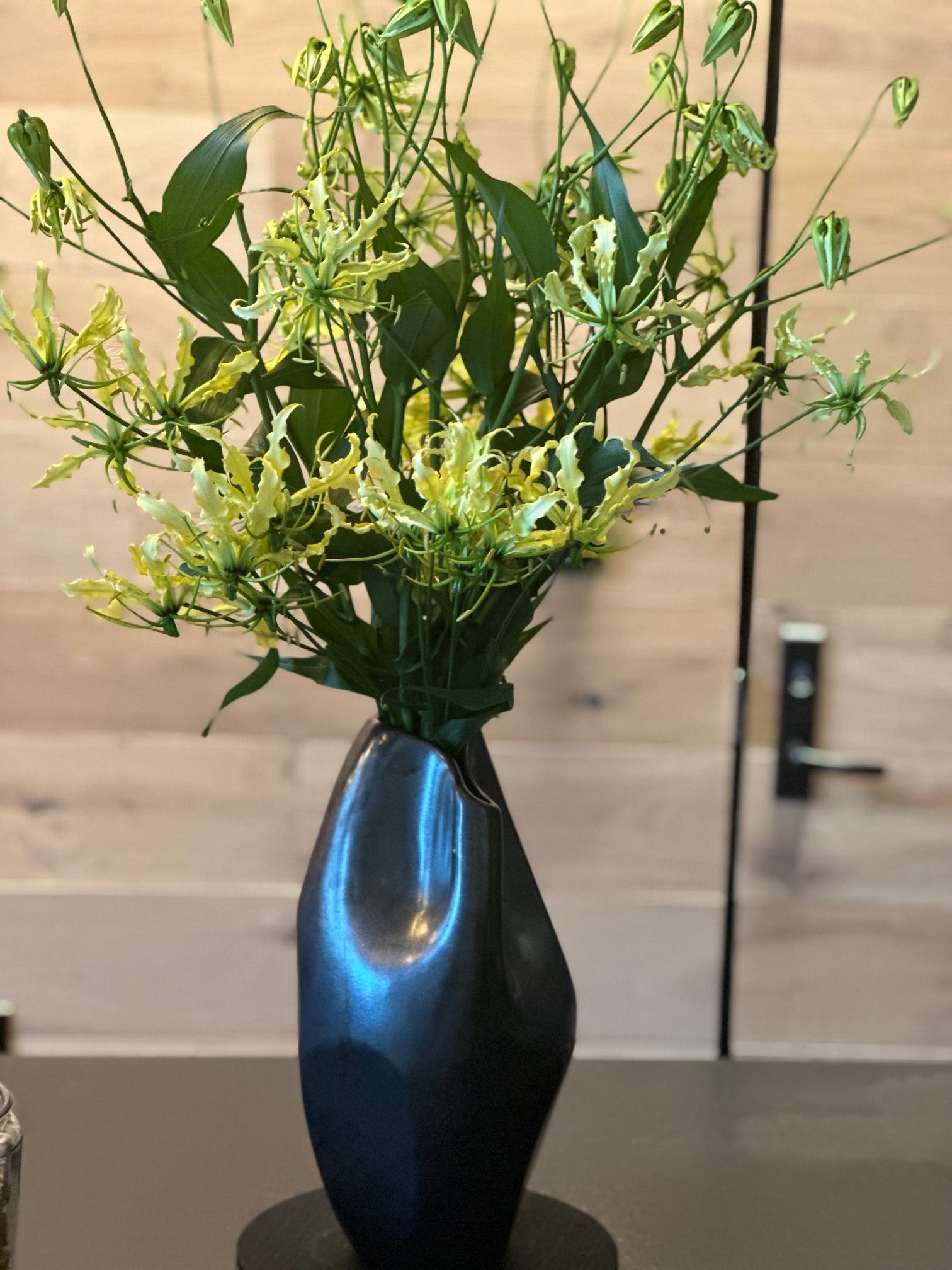 A vase filled with flowers is sitting on a table.