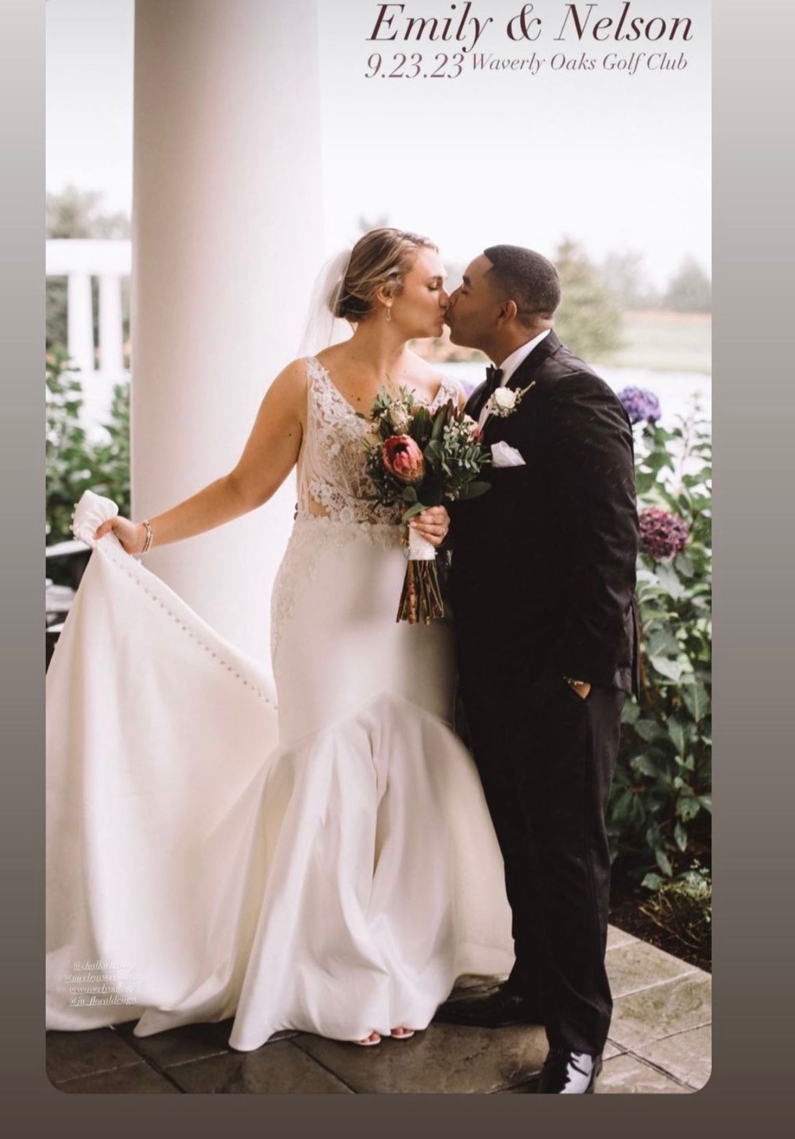 A bride and groom kissing on a porch on their wedding day.