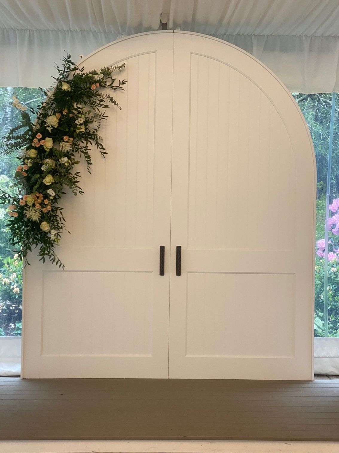 A white door with flowers on it in a room.