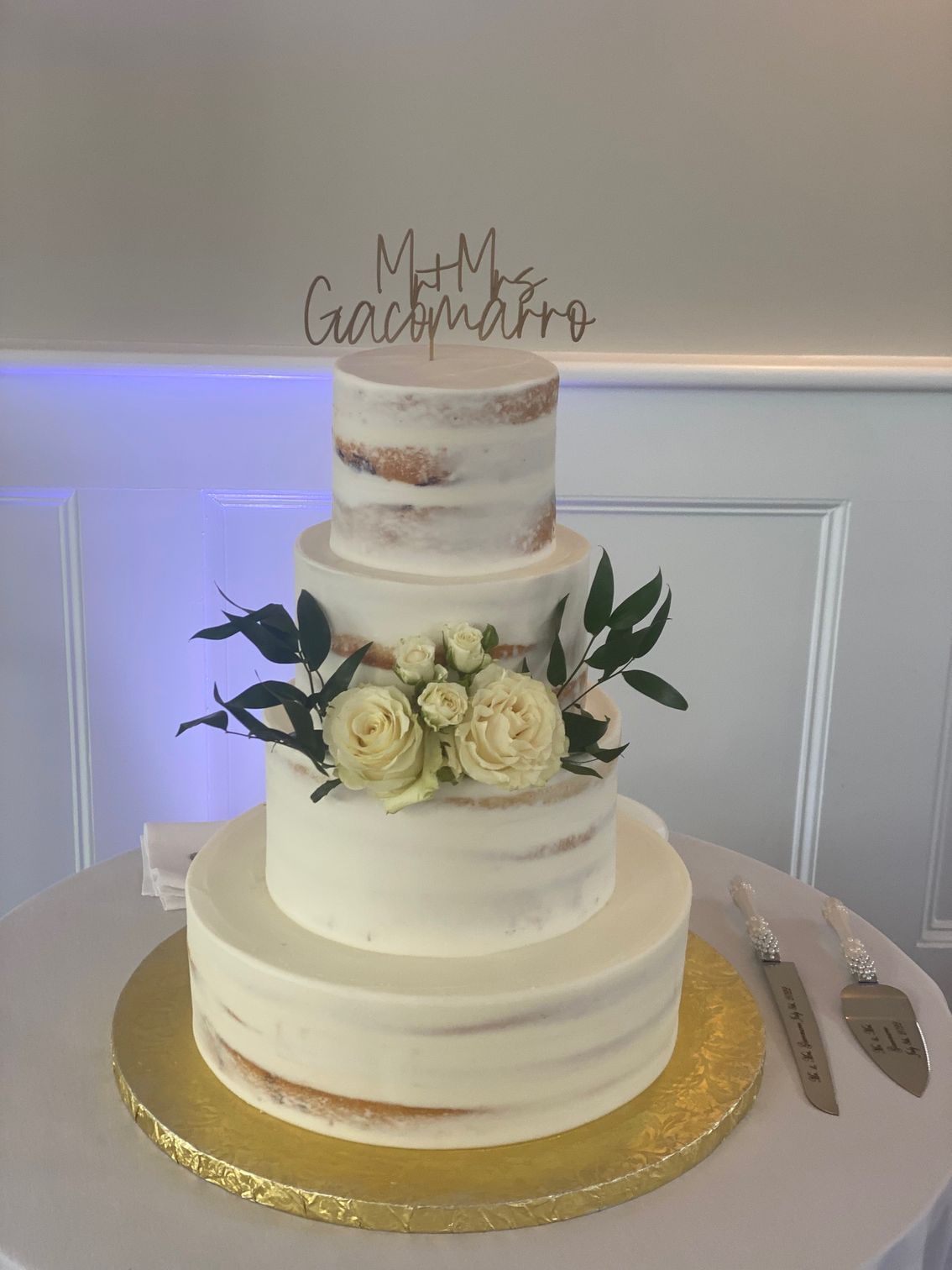 A wedding cake is sitting on top of a table.