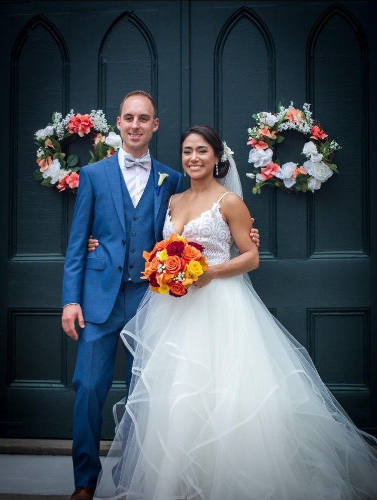 Married Couple in Front of Doors