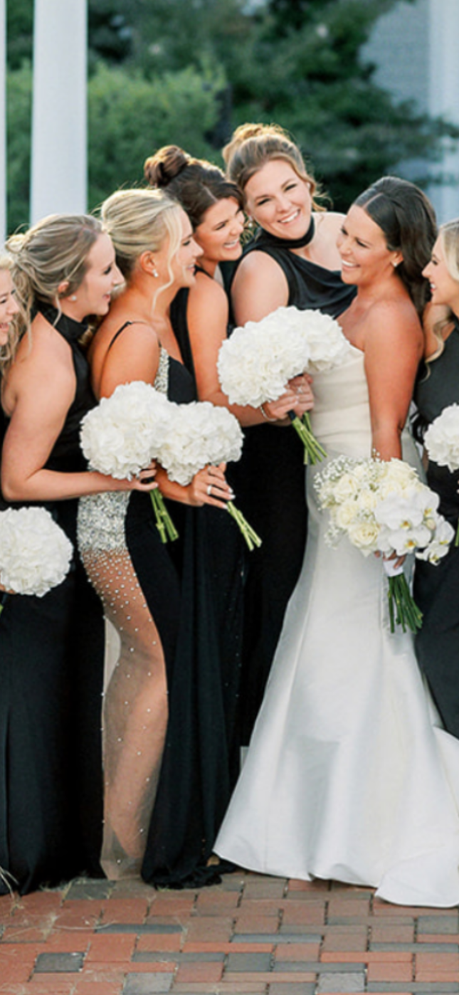 A bride and her bridesmaids are posing for a picture.