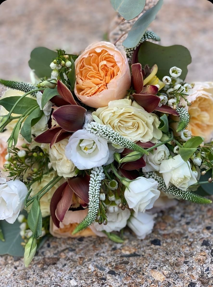 A bouquet of flowers is sitting on the ground.