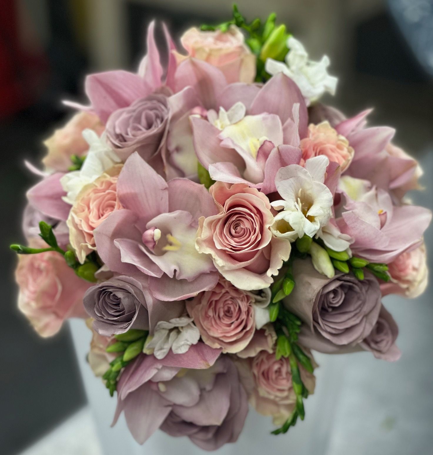 A bouquet of pink and white flowers is sitting on a table.