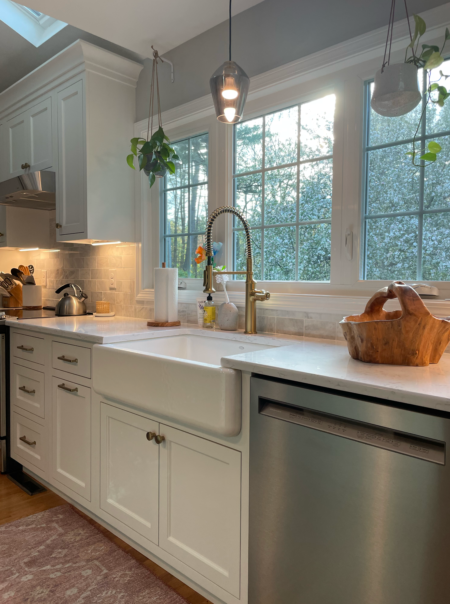 A new kitchen with white cabinets and stainless steel appliances.