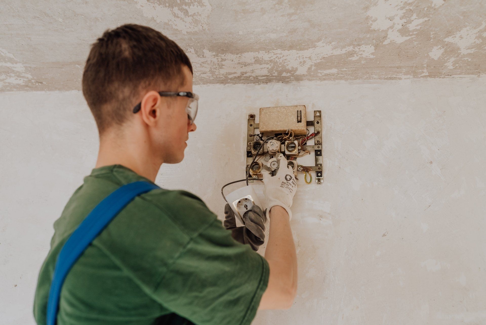 electrician installing fixture
