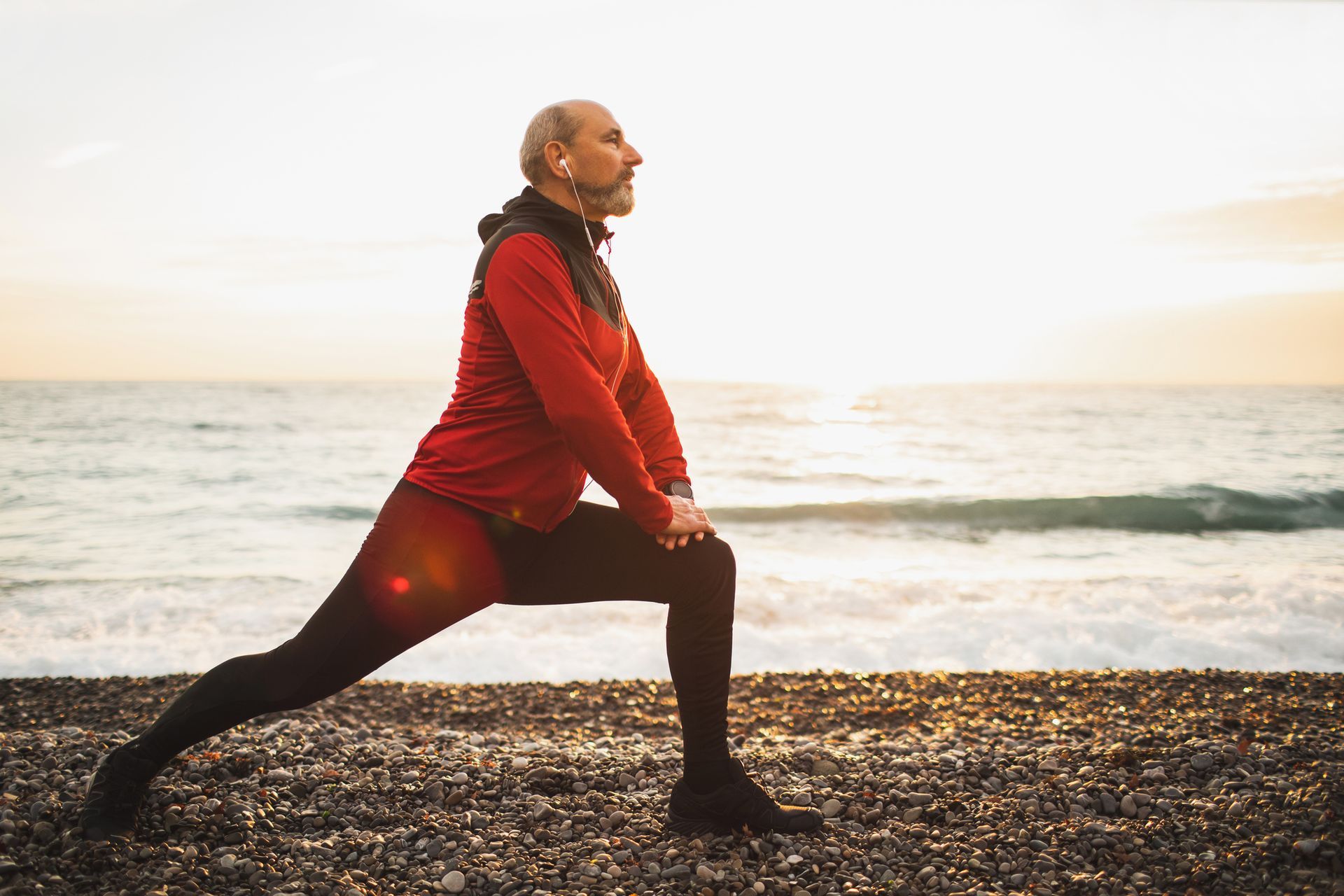 A woman with a backpack is walking through a forest.