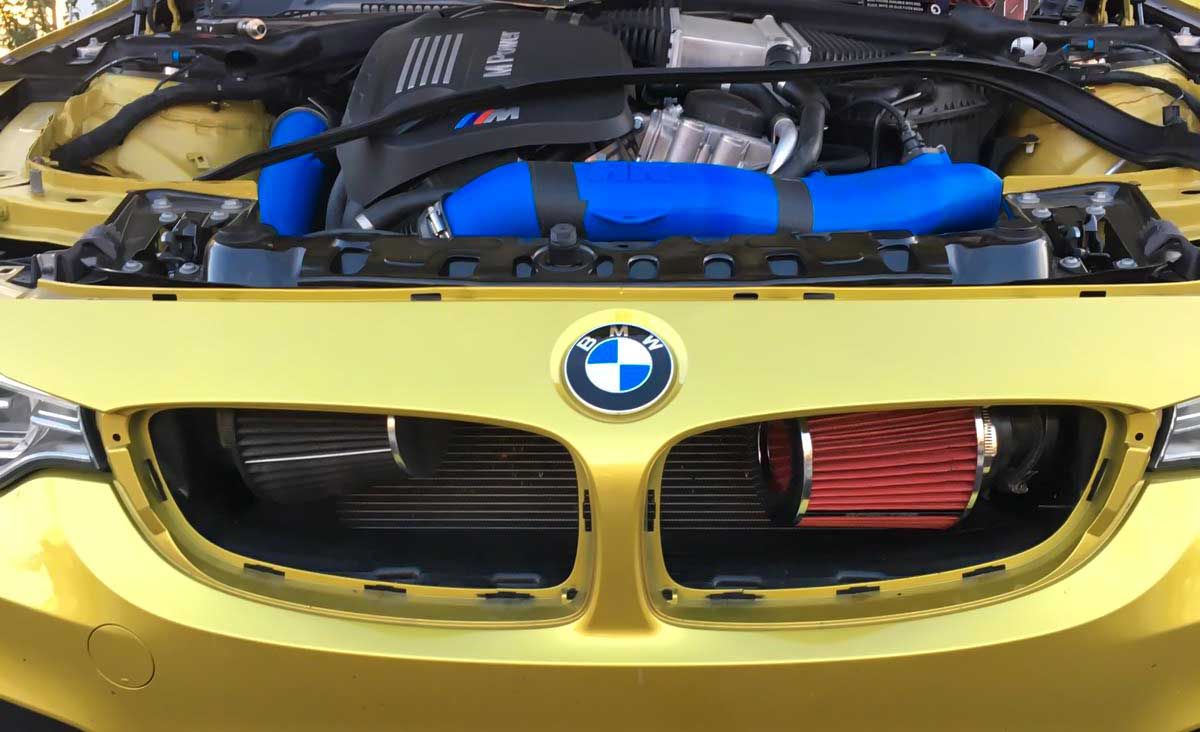 F82 BMW M4 front mount air intakes being installed 