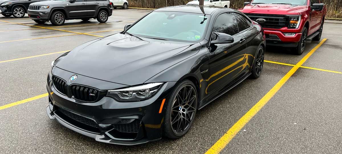 black BMW M4 with CS Style carbon fiber front lip 