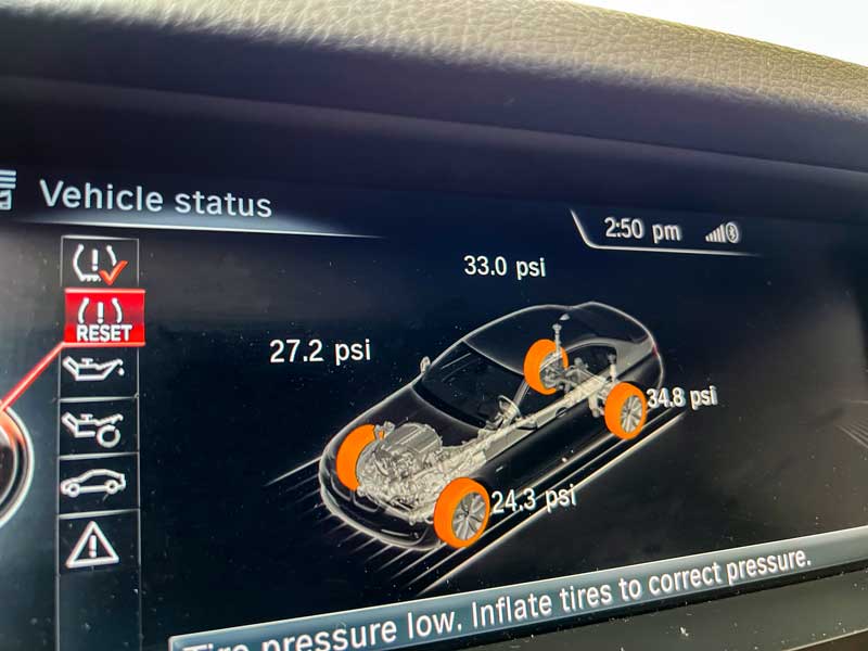 bmw idrive showing low tire pressure on the dashboard