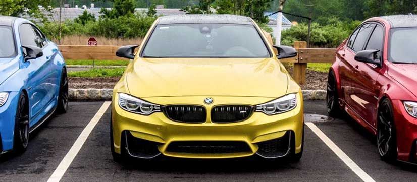 austin yellow bmw m4 with carbon fiber fangs, otherwise called front splitters